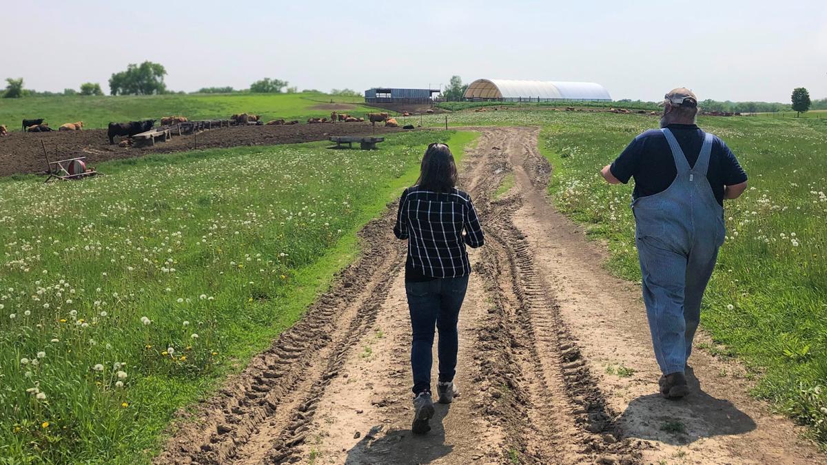 Rep Angie Craig walking with farmer