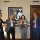 Rep. Angie Craig doing an “elbow bump” with Commissioner Jennifer Ho, Jessica Deegan and Ryan Baumtrog.